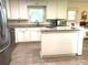 Bright kitchen features white cabinets, an island, and granite countertops providing ample workspace at 4040 Summit Dr, Marietta, GA 30068