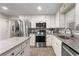 Modern kitchen with granite countertops, stainless steel appliances, and white cabinetry at 4040 Summit Dr, Marietta, GA 30068