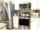 Modern kitchen features stainless steel appliances, white cabinets, and granite countertops at 4040 Summit Dr, Marietta, GA 30068