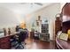 Bright home office featuring hardwood floors, vaulted ceiling, and custom shelving for storage at 4040 Summit Dr, Marietta, GA 30068