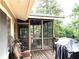 Charming screened porch with a wooden deck, perfect for outdoor dining and relaxation at 4040 Summit Dr, Marietta, GA 30068