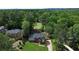 Expansive aerial view of the home showcasing mature trees and a well-maintained lawn, highlighting the neighborhood at 10310 Amberside Ct, Roswell, GA 30076