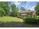 Expansive backyard with a well-maintained lawn, established trees, and a private fence perfect for outdoor living at 10310 Amberside Ct, Roswell, GA 30076