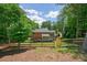 Spacious backyard featuring lush greenery, a wooden fence, and a serene, secluded outdoor space at 10310 Amberside Ct, Roswell, GA 30076