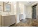 Bathroom featuring double vanity with marble countertops and glass-enclosed shower with decorative tile surround at 10310 Amberside Ct, Roswell, GA 30076