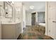 Well-appointed bathroom with glass shower, soaking tub, and stone tile floor at 10310 Amberside Ct, Roswell, GA 30076