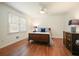 Bright bedroom with hardwood floors, natural light, and modern ceiling fan at 10310 Amberside Ct, Roswell, GA 30076