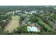 Panoramic aerial shot of the community showcasing the pool, tennis courts, golf course, and lakeside homes at 10310 Amberside Ct, Roswell, GA 30076