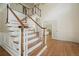 Elegant foyer with a staircase, hardwood floors, and paneled walls, offering a view into the living spaces at 10310 Amberside Ct, Roswell, GA 30076