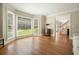 Light-filled living room features large windows and beautiful hardwood floors, creating a warm and inviting space at 10310 Amberside Ct, Roswell, GA 30076