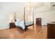 Spacious main bedroom with hardwood floors, vaulted ceiling, and modern chandelier at 10310 Amberside Ct, Roswell, GA 30076