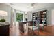 Office with built in shelving, a large desk and a large bay window providing natural light and green views at 10310 Amberside Ct, Roswell, GA 30076