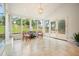 Cozy sunroom with many windows, tile floors, and views of the backyard at 10310 Amberside Ct, Roswell, GA 30076