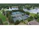 Aerial view of neighborhood tennis courts, nestled by the lake, perfect for sports and recreation at 10310 Amberside Ct, Roswell, GA 30076