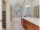 A long vanity with natural wood cabinets and double sinks are featured in this bathroom at 1411 Primrose Park Rd, Sugar Hill, GA 30518