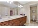 Large bathroom featuring a double sink vanity with dark wood cabinets and a separate toilet room at 1411 Primrose Park Rd, Sugar Hill, GA 30518