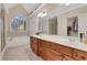 Bathroom showcasing vanity with dual sinks, large mirror, garden tub, and walk-in shower at 1411 Primrose Park Rd, Sugar Hill, GA 30518