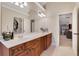 A vanity featuring double sinks and a large mirror are seen in this bright bathroom at 1411 Primrose Park Rd, Sugar Hill, GA 30518