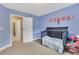 Light blue Bedroom featuring a crib and large window with natural light at 1411 Primrose Park Rd, Sugar Hill, GA 30518