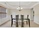 Elegant dining room featuring modern table and chair set, wainscoting, and decorative chandelier at 1411 Primrose Park Rd, Sugar Hill, GA 30518