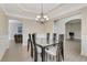 Dining room showcasing an elegant light fixture, neutral walls and doorways to other rooms at 1411 Primrose Park Rd, Sugar Hill, GA 30518