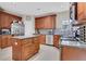 Well-equipped kitchen with wood cabinetry, center island, and stainless steel appliances at 1411 Primrose Park Rd, Sugar Hill, GA 30518