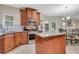 Kitchen area with wood cabinets, granite counters, and stainless steel appliances at 1411 Primrose Park Rd, Sugar Hill, GA 30518