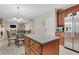 Eat-in kitchen features wood cabinets, granite counters, and stainless steel appliances at 1411 Primrose Park Rd, Sugar Hill, GA 30518