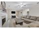Inviting living room with a large sectional sofa, fireplace, and light wood floors at 1411 Primrose Park Rd, Sugar Hill, GA 30518
