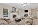 Cozy living room features a fireplace, large sectional, and neutral decor at 1411 Primrose Park Rd, Sugar Hill, GA 30518