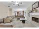 Spacious living room area featuring a fireplace with direct views into the open concept kitchen at 1411 Primrose Park Rd, Sugar Hill, GA 30518