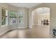 Bright living room with an archway leading to the dining area with plenty of natural light at 1411 Primrose Park Rd, Sugar Hill, GA 30518
