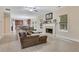 Open concept living area with a fireplace, adjacent to a cozy kitchen and hardwood style flooring at 1411 Primrose Park Rd, Sugar Hill, GA 30518