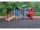 Colorful playground with multiple slides, climbing structures, and soft rubber ground cover in a park setting at 1411 Primrose Park Rd, Sugar Hill, GA 30518