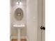 Functional powder room with pedestal sink and modern fixtures at 1411 Primrose Park Rd, Sugar Hill, GA 30518