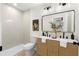Modern bathroom featuring a double vanity with wicker-style cabinets and a standing shower at 1980 Oakdale Se Ct, Smyrna, GA 30082