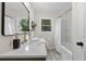 Modern bathroom with shower and updated vanity, faucet, and designer tile floor at 1980 Oakdale Se Ct, Smyrna, GA 30082