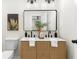 Bathroom features a double sink vanity, a decorative mirror, and modern fixtures and lighting at 1980 Oakdale Se Ct, Smyrna, GA 30082