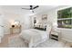 Bright bedroom featuring neutral walls, bright windows, ceiling fan, and a comfy bed at 1980 Oakdale Se Ct, Smyrna, GA 30082