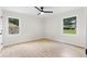 Bedroom featuring light wood floors, neutral walls, base molding, and windows offering views of the outdoors at 1980 Oakdale Se Ct, Smyrna, GA 30082