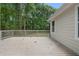 Back deck showcasing wood flooring, a light exterior, and overlooks the tree-filled backyard at 1980 Oakdale Se Ct, Smyrna, GA 30082
