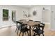 Elegant dining area with a large wooden table, modern chairs, and french doors at 1980 Oakdale Se Ct, Smyrna, GA 30082