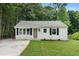 Charming bungalow-style home with a well-maintained lawn and a welcoming front entrance at 1980 Oakdale Se Ct, Smyrna, GA 30082