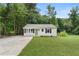 Front exterior showcasing a well-maintained lawn, siding, a driveway, and a charming entrance at 1980 Oakdale Se Ct, Smyrna, GA 30082