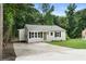 Charming home featuring a well-kept lawn, driveway, siding, and an inviting front entrance at 1980 Oakdale Se Ct, Smyrna, GA 30082