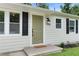 Close-up of the home's front door, showcasing modern fixtures, a welcome mat, and updated siding at 1980 Oakdale Se Ct, Smyrna, GA 30082