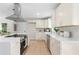 Bright kitchen featuring modern countertops, stainless appliances, and bright white cabinets with gold pulls at 1980 Oakdale Se Ct, Smyrna, GA 30082