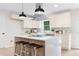 Bright, open kitchen featuring a large island with seating, modern appliances, and stylish pendant lighting at 1980 Oakdale Se Ct, Smyrna, GA 30082