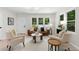 Inviting living room with large windows and cozy seating arrangements, perfect for relaxation at 1980 Oakdale Se Ct, Smyrna, GA 30082
