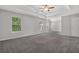 Large bedroom featuring tray ceilings, and multiple windows for ample natural light at 6032 Trotters Cir, Fairburn, GA 30213